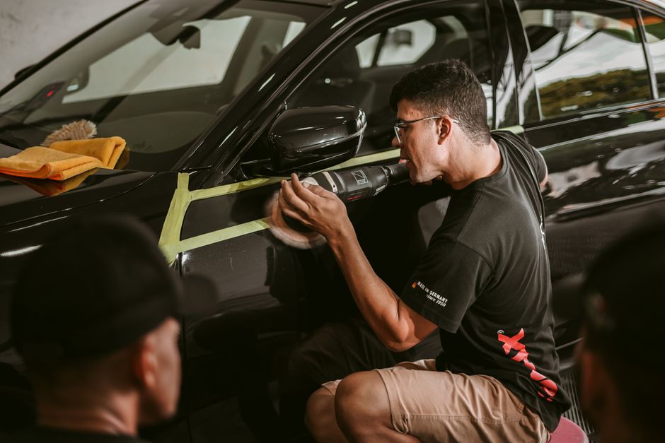 Detailer carefully polishing a vehicle's exterior